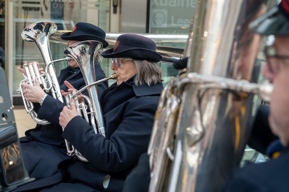 Salvation Army Band members playing brass instruments at the Merrion Centre